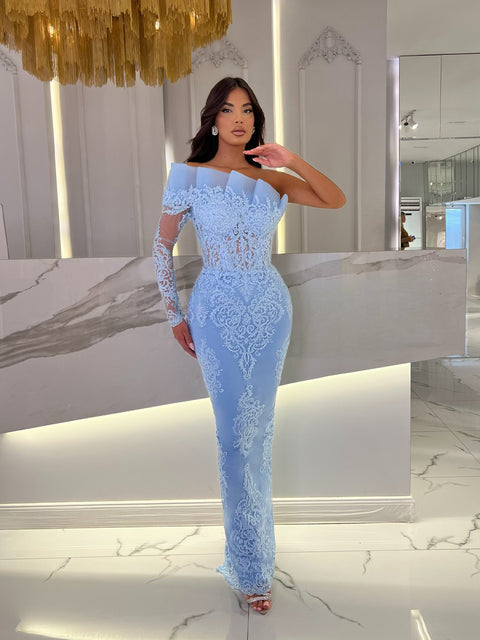 baby blue dress featuring an asymmetrical neckline and a ruffle detail