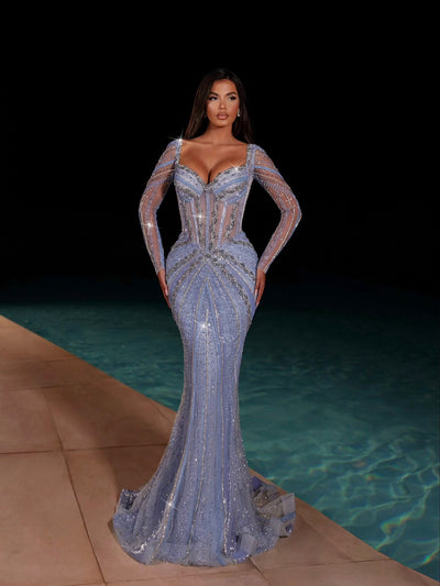 blue evening gown featuring long sleeves and a long tail