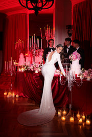 white dress featuring an open back and a long tail