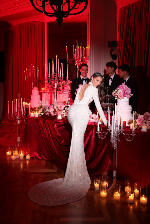 white dress featuring an open back and a long tail