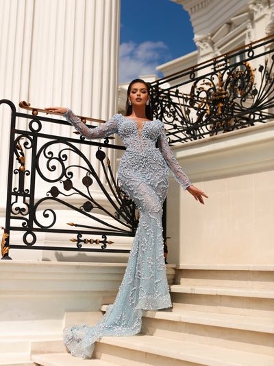 a light blue dress featuring long sleeves and a long tail